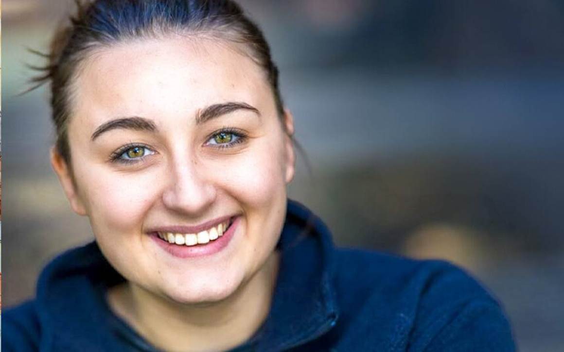 teen girl smiling at the camera.